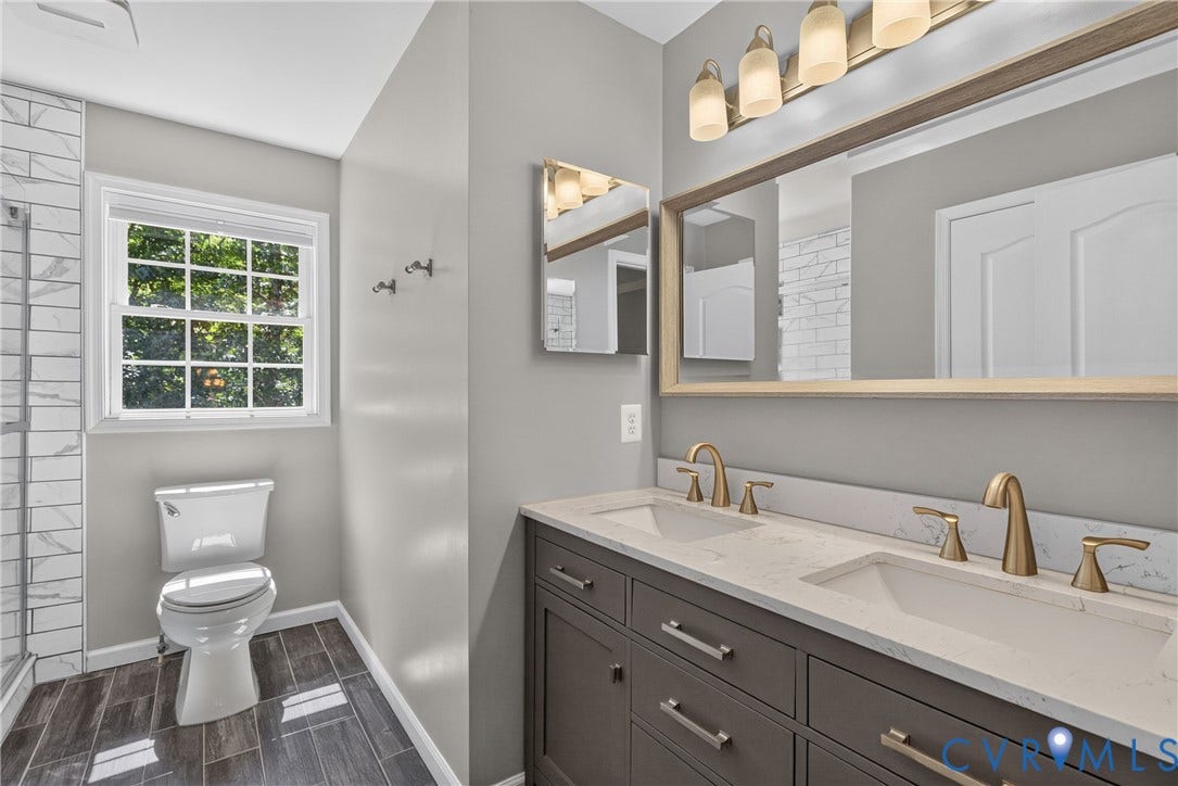 381 Shorewood Drive, Shorewood, Mineral, VA 23117 Hall bathroom - Double vanity with gold-finish faucets and hardware, set against a light gray wall