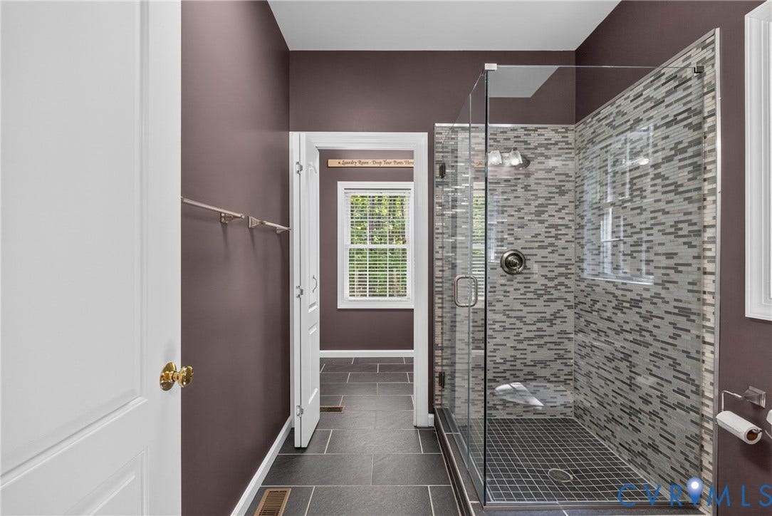 381 Shorewood Drive, Shorewood, Mineral, VA 23117 Glass-enclosed shower featuring mosaic tile surround and a tiled floor