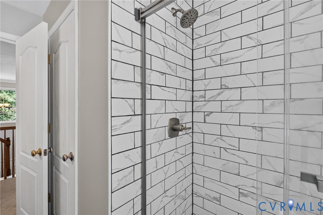 381 Shorewood Drive, Shorewood, Mineral, VA 23117 Hall bathroom - Subway tile shower surround with a rainfall showerhead, brushed nickel fixtures, and a clear glass enclosure