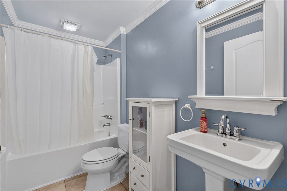 381 Shorewood Drive, Shorewood, Mineral, VA 23117 Bathroom in basement featuring a pedestal sink with chrome faucet, framed mirror, and a shower-tub combination
