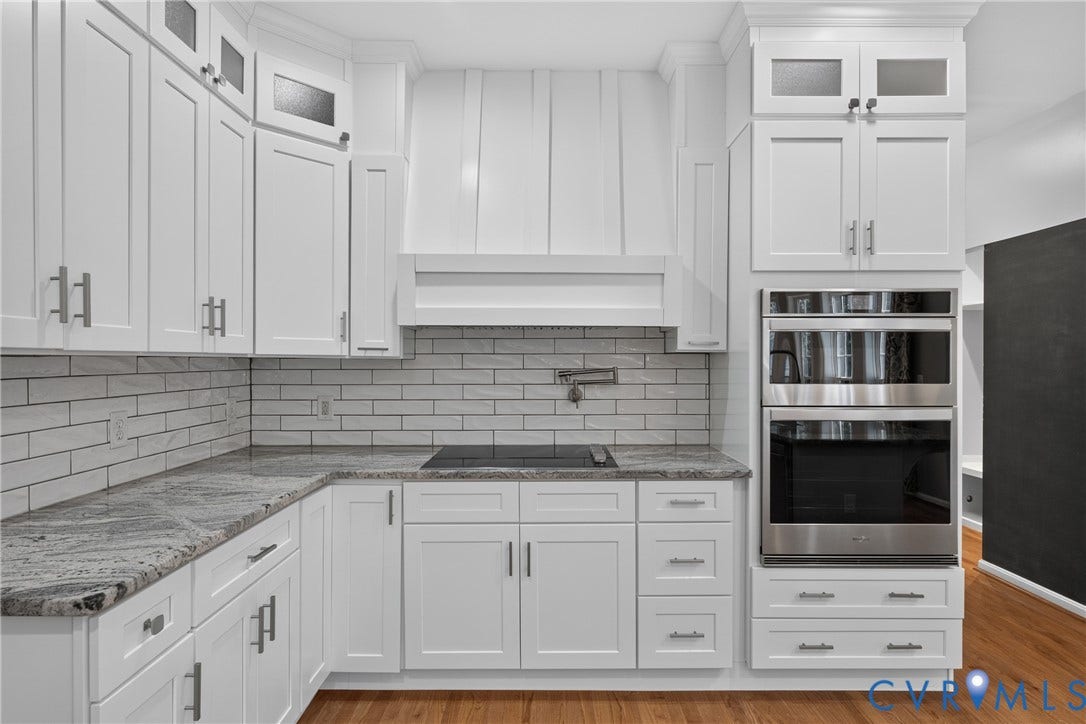 381 Shorewood Drive, Shorewood, Mineral, VA 23117 White shaker cabinetry with brushed nickel hardware, granite countertops, and a subway tile backsplash