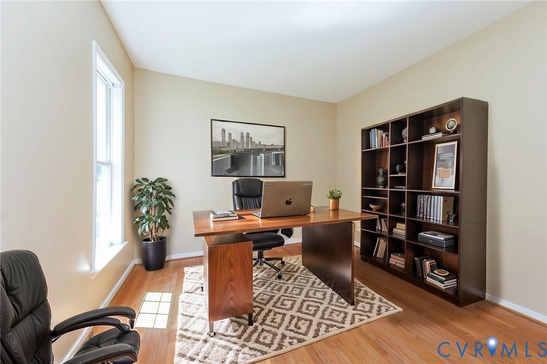 Bright room featuring light-colored walls and wood-finish flooring