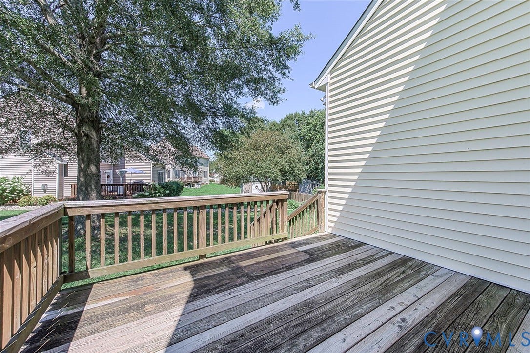 Wood-finish deck featuring a railing system and steps