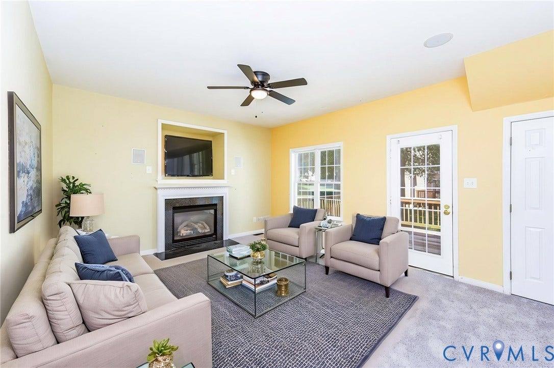 Living area featuring a built-in fireplace with a black surround and white mantel