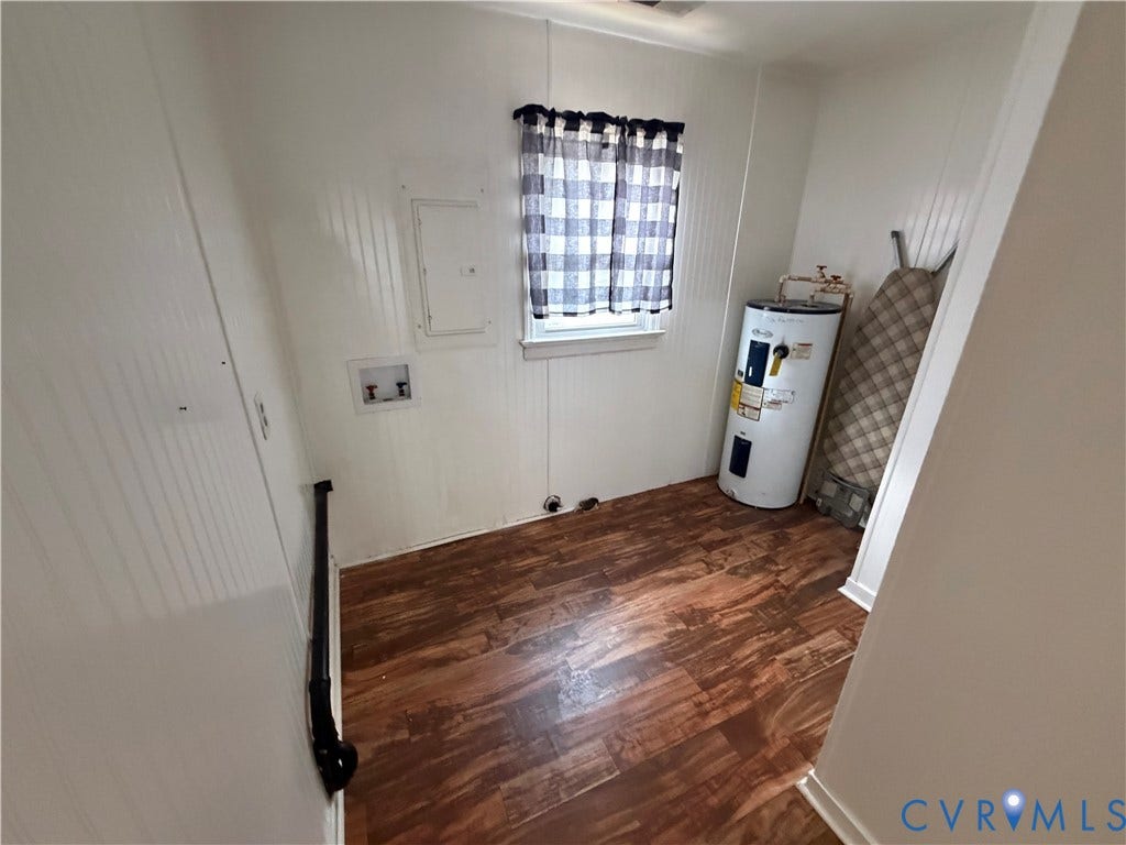2206 Lancers Boulevard, Richmond, VA 23224 Utility space featuring wood-finish flooring, white paneled walls, and a window with a valance