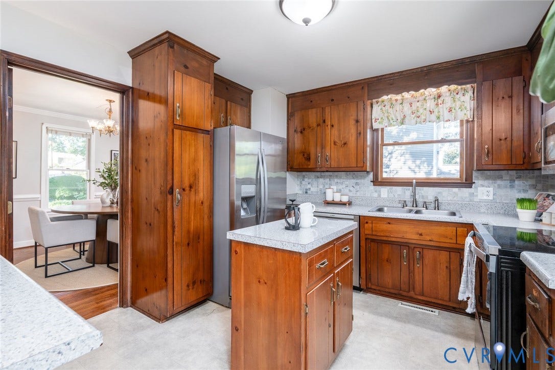 14613 Gimbel Drive, Chester, VA 23836 Kitchen featuring wood cabinetry, light-toned countertops, and a tile backsplash
