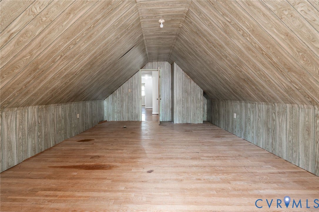 14613 Gimbel Drive, Chester, VA 23836 Sloped wood-paneled ceiling, wood-finish flooring, recessed wall panels, exposed light fixture, and interior doorways