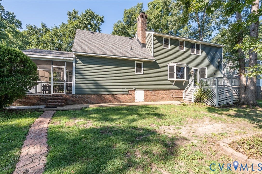 14613 Gimbel Drive, Chester, VA 23836 Green siding exterior with a screened porch, brick foundation, multi-level deck, and bay window