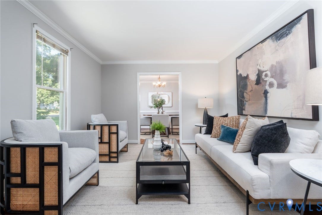 14613 Gimbel Drive, Chester, VA 23836 Living area featuring light-toned wall finishes, crown molding, a large window, and an open doorway to another room
