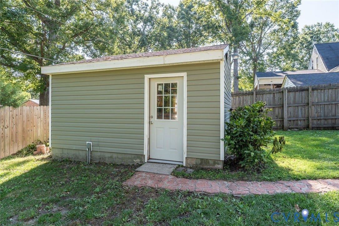 14613 Gimbel Drive, Chester, VA 23836 Detached outbuilding with horizontal siding, a white door with lites, and a brick pathway