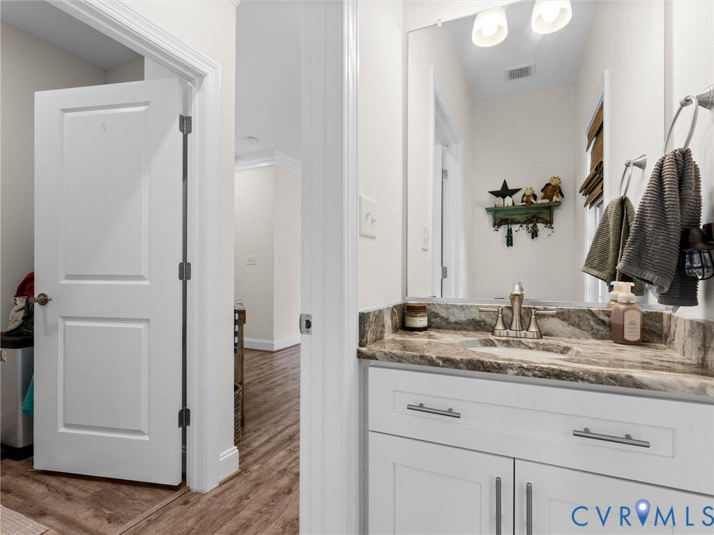 8200 Madeline Court, Strath Woods, Henrico, VA 23231 Bathroom vanity featuring a rectangular under-mount sink, a patterned stone countertop, and a brushed nickel faucet