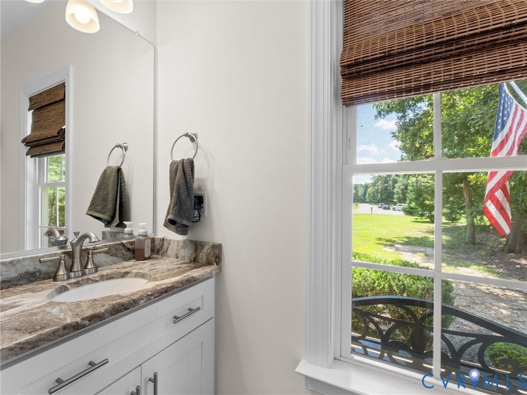 8200 Madeline Court, Strath Woods, Henrico, VA 23231 Bathroom featuring a single vanity with a patterned countertop, undermount sink, and brushed nickel faucet