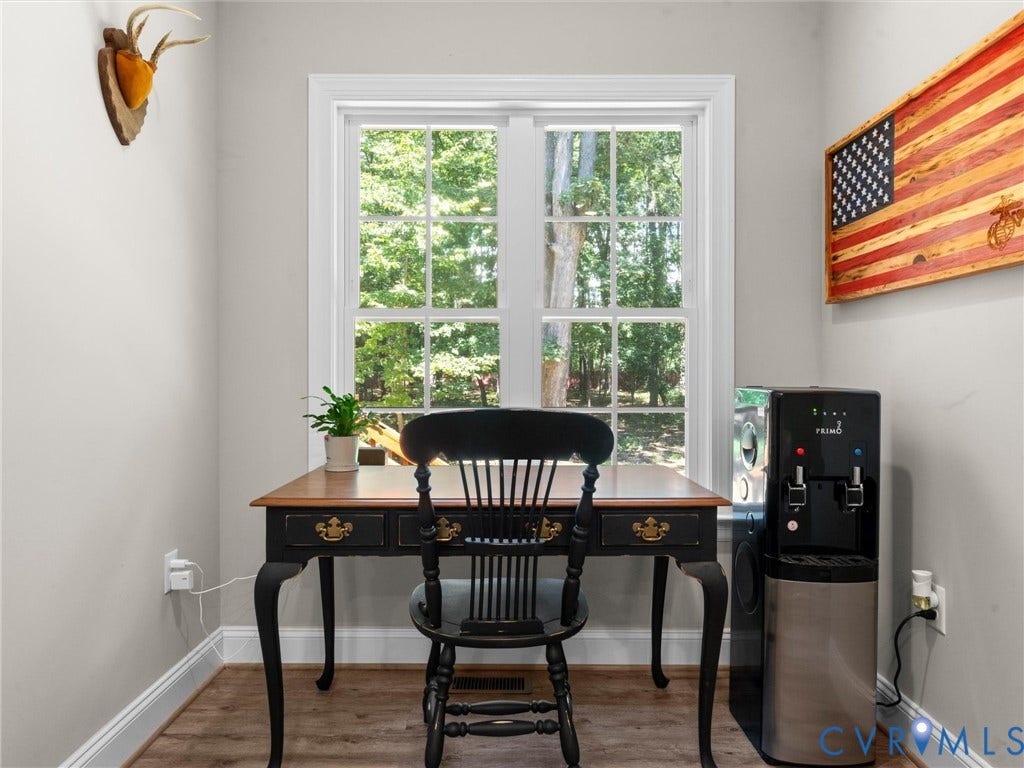 8200 Madeline Court, Strath Woods, Henrico, VA 23231 Bright room featuring a large window with white trim, wood-finish flooring, and light-toned walls
