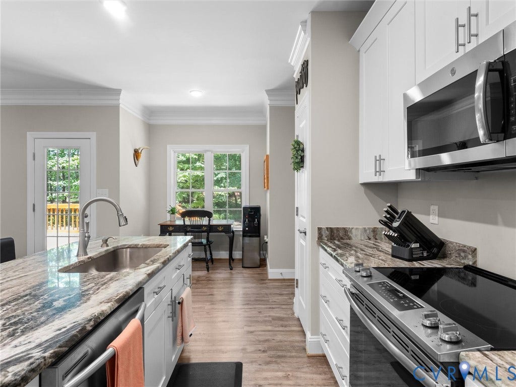8200 Madeline Court, Strath Woods, Henrico, VA 23231 Kitchen featuring wood-finish flooring, white cabinetry, integrated stainless steel appliances, and stone-finish countertops