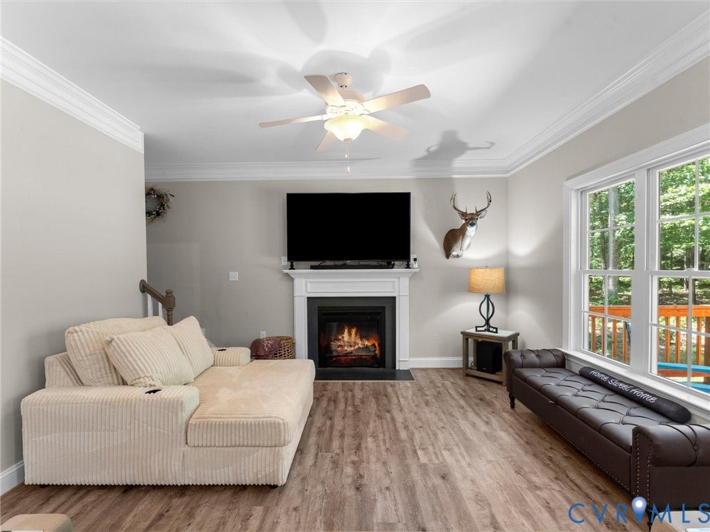 8200 Madeline Court, Strath Woods, Henrico, VA 23231 Living space featuring wood-finish flooring and a central fireplace with a white mantel