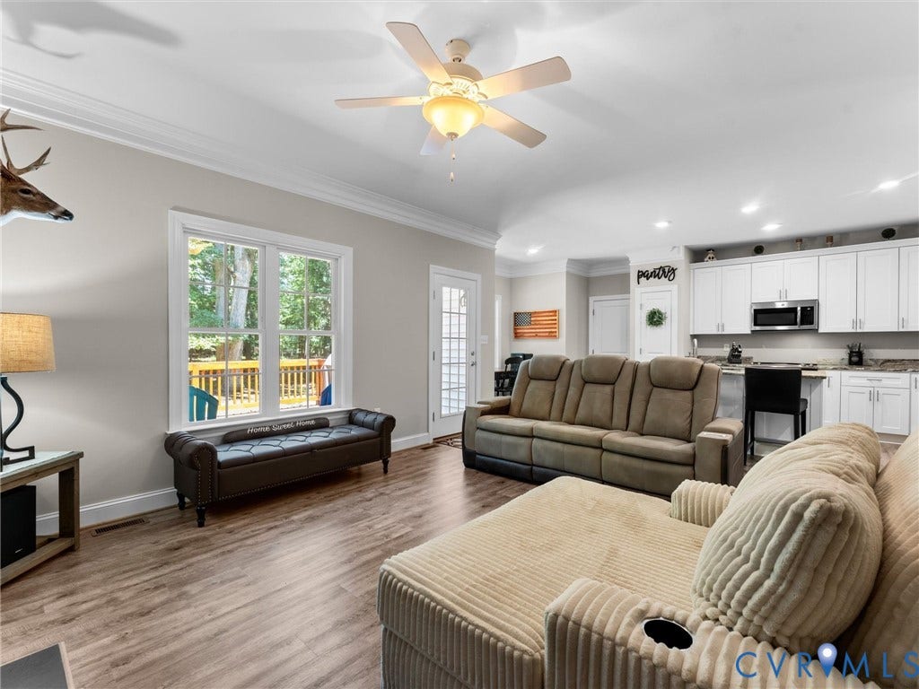 8200 Madeline Court, Strath Woods, Henrico, VA 23231 Open-concept living space featuring wood-finish flooring, a white ceiling fan, and crown molding