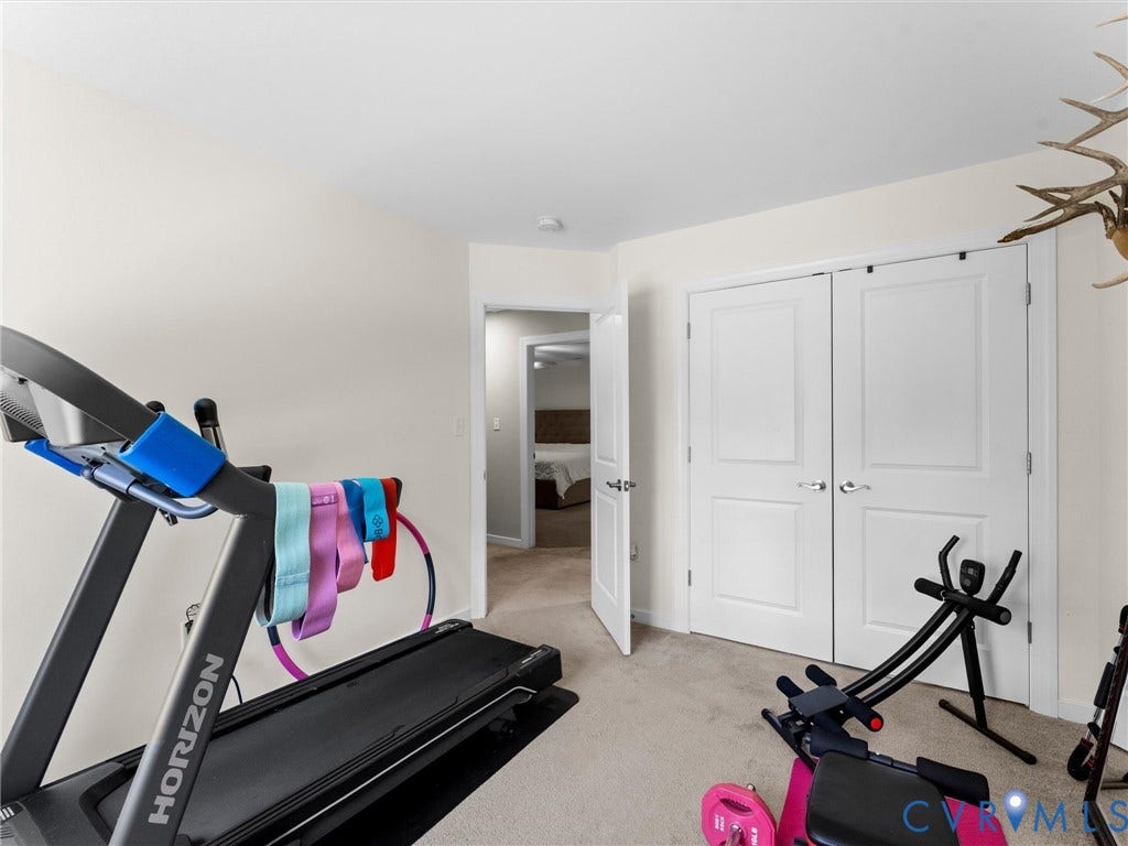 8200 Madeline Court, Strath Woods, Henrico, VA 23231 Neutral-toned room with plush carpet flooring, showcasing a double-door closet with chrome hardware