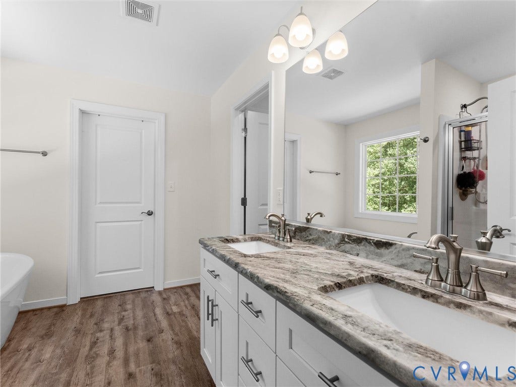 8200 Madeline Court, Strath Woods, Henrico, VA 23231 Bathroom featuring a double vanity with stone countertops and undermount sinks