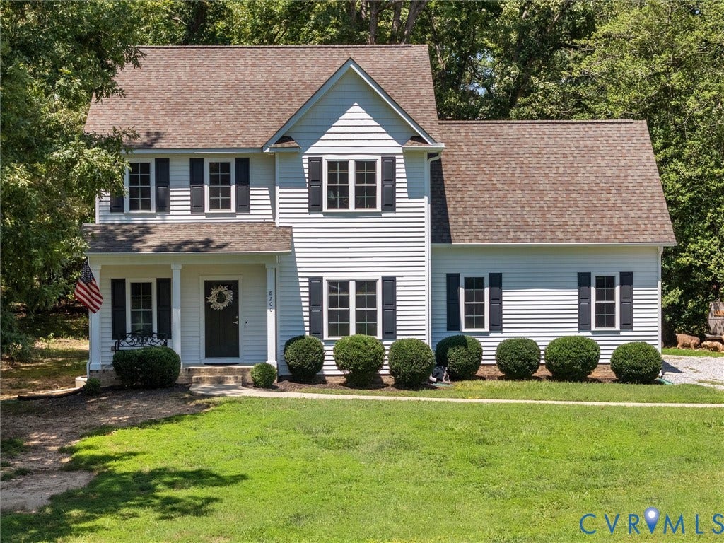 8200 Madeline Court, Strath Woods, Henrico, VA 23231 Two-story residence featuring white siding, dark shutters, a covered front porch with white columns, and a shingle roof