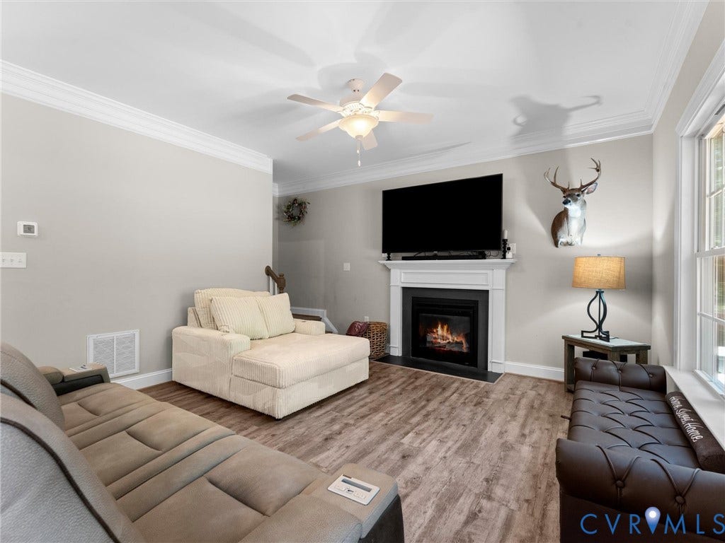 8200 Madeline Court, Strath Woods, Henrico, VA 23231 Living area featuring a fireplace with a white mantel, dark surround, and hearth