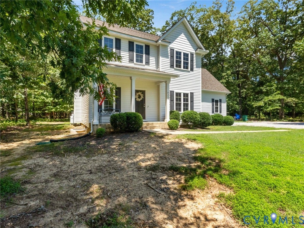 8200 Madeline Court, Strath Woods, Henrico, VA 23231 Two-story residence featuring white siding and black window shutters