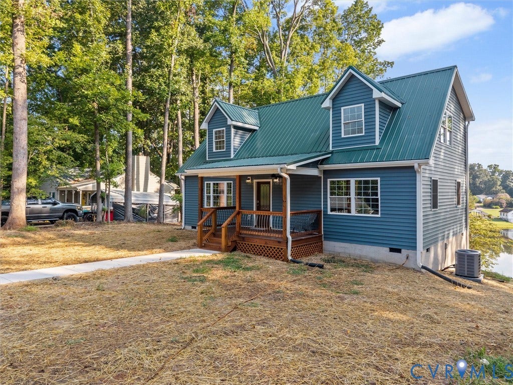 2224 Highland Drive, Powhatan, VA 23139 Two-story home featuring blue siding and a green metal roof