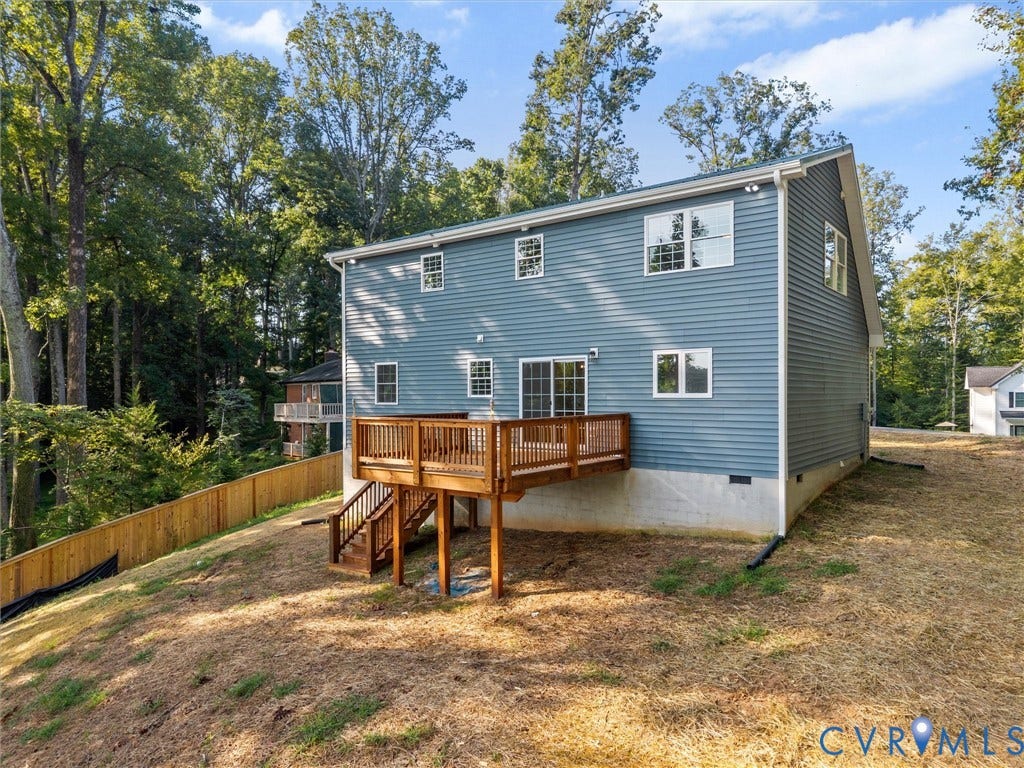 2224 Highland Drive, Powhatan, VA 23139 Multi-story exterior with blue siding, a multi-level deck, and a wooden privacy fence