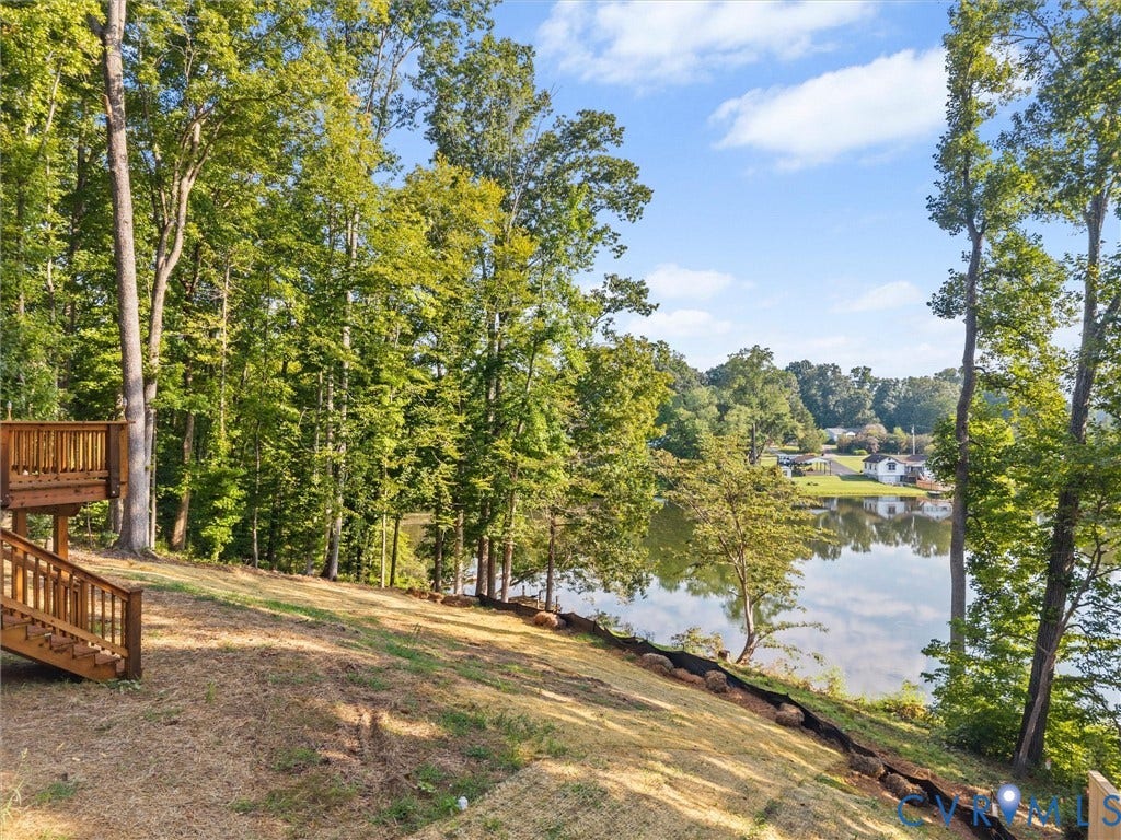 2224 Highland Drive, Powhatan, VA 23139 Tiered wood deck with stairs, expansive lawn, mature trees, and waterfront access