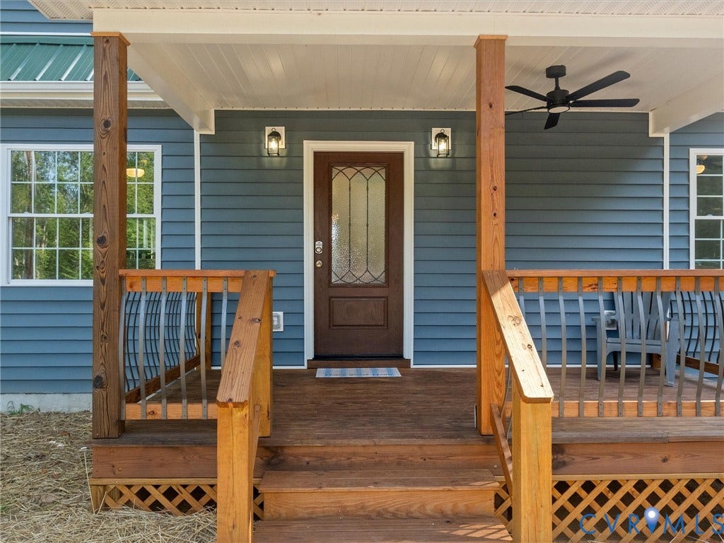 2224 Highland Drive, Powhatan, VA 23139 Front porch featuring wood steps, wood pillars, wood railing with metal balusters, and a dark wood entry door with decorative glass