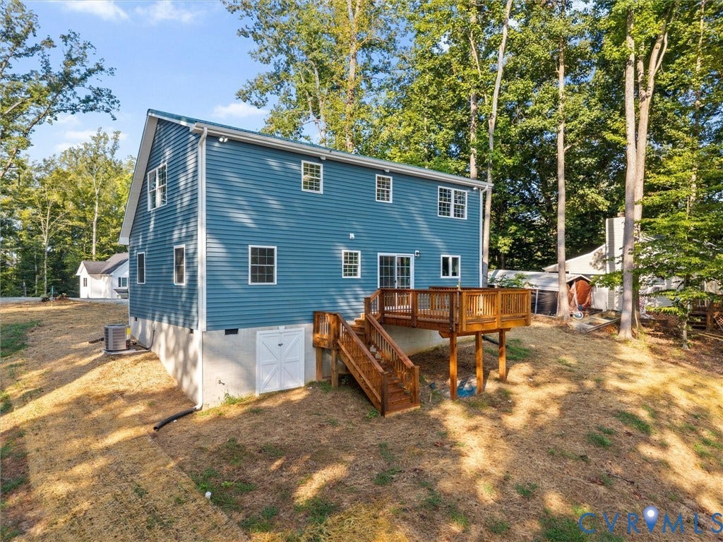 2224 Highland Drive, Powhatan, VA 23139 Expansive rear deck with wooden railing and stairs, offering outdoor living space