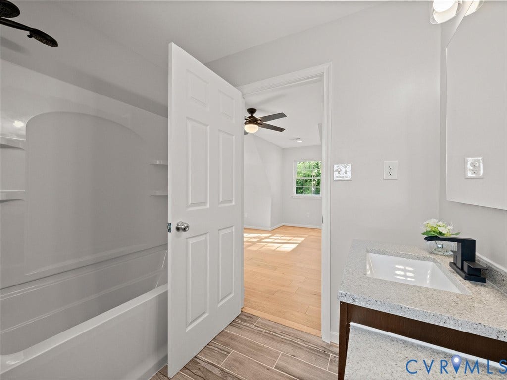 2224 Highland Drive, Powhatan, VA 23139 White vanity with a rectangular basin sink, black single-handle faucet, and light-toned countertop