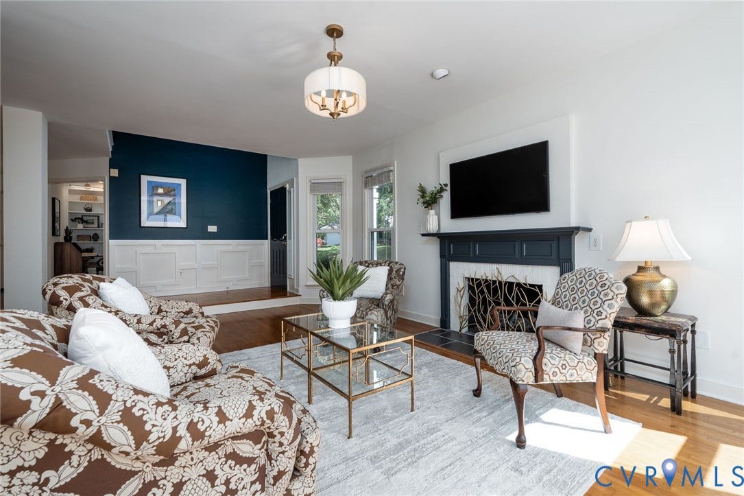1719 Logwood Circle, Henrico, VA 23238 Great room: Hardwood flooring, gas fireplace, recessed lighting, and a contemporary chandelier