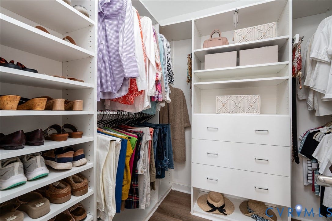 1719 Logwood Circle, Henrico, VA 23238 Primary closet: Custom closet system featuring multiple shelving units, built-in drawer storage, and hanging rods