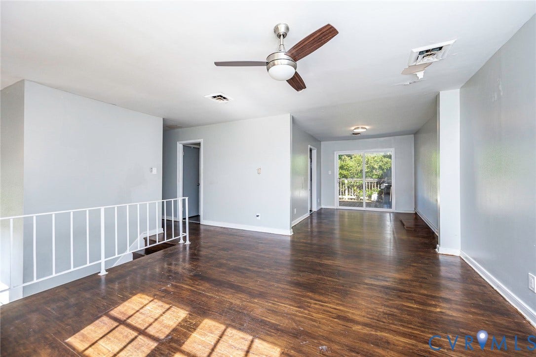 124 Northfield Lane, North Chesterfield, VA 23236 Wood-finish flooring throughout, ceiling fan with integrated lighting, white railing, and sliding glass door
