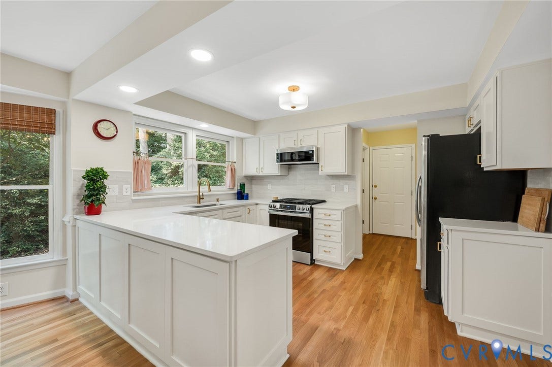 3704 Milbrier Place, Henrico, VA 23233 White cabinetry with gold-tone hardware, wood-finish flooring, recessed lighting, and a white tile backsplash