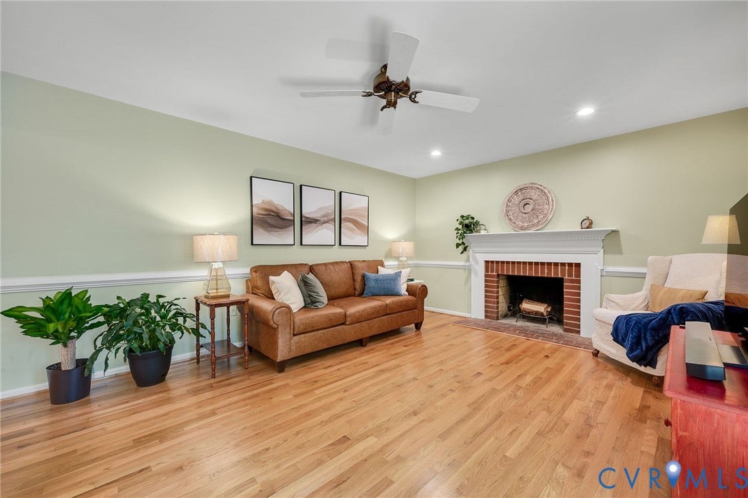 3704 Milbrier Place, Henrico, VA 23233 Hardwood flooring, brick fireplace with white mantel, recessed lighting, ceiling fan, and chair rail molding
