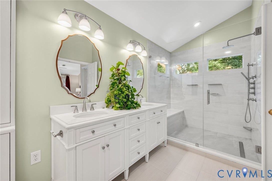 3704 Milbrier Place, Henrico, VA 23233 Primary Bath dual vanity with undermount sinks, frameless glass shower enclosure, shower bench, built-in shower niches, and an angled ceiling