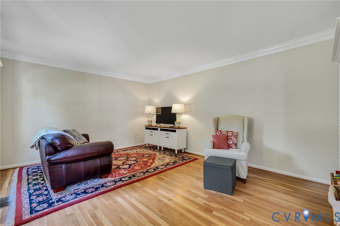 3704 Milbrier Place, Henrico, VA 23233 Hardwood flooring, light-colored wall paint, white crown molding, and white baseboards