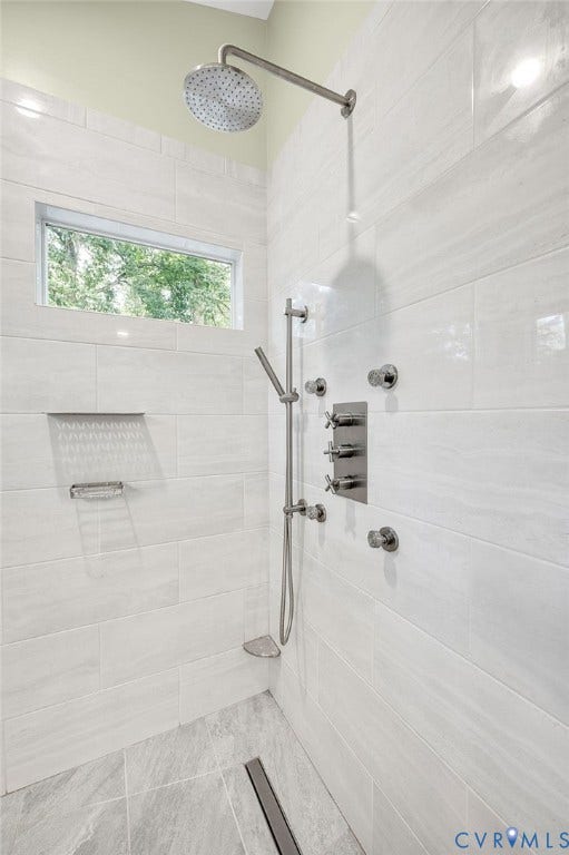 3704 Milbrier Place, Henrico, VA 23233 Primary Bath shower with large format wall tiling, a rainfall showerhead, and a separate handheld shower