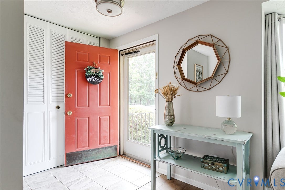 1723 Misty Dawn Court, Henrico, VA 23238 Entryway featuring a six-panel door, louvered bi-fold closet doors, tile flooring, and a flush-mount ceiling light fixture