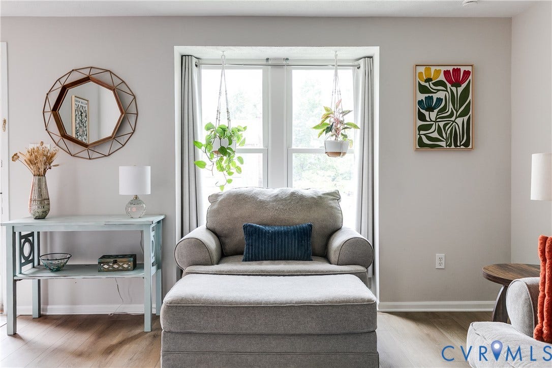 1723 Misty Dawn Court, Henrico, VA 23238 Bright living space featuring a large window with natural light, neutral wall colors, wood-finish flooring, and white baseboards