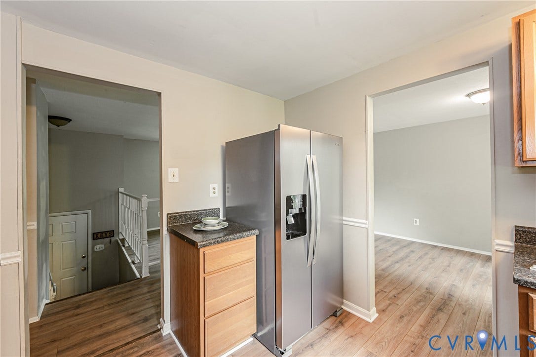 9406 Emmett Court, Glen Allen, VA 23060 Kitchen space featuring wood-finish flooring, a stainless steel refrigerator, and granite-style countertops