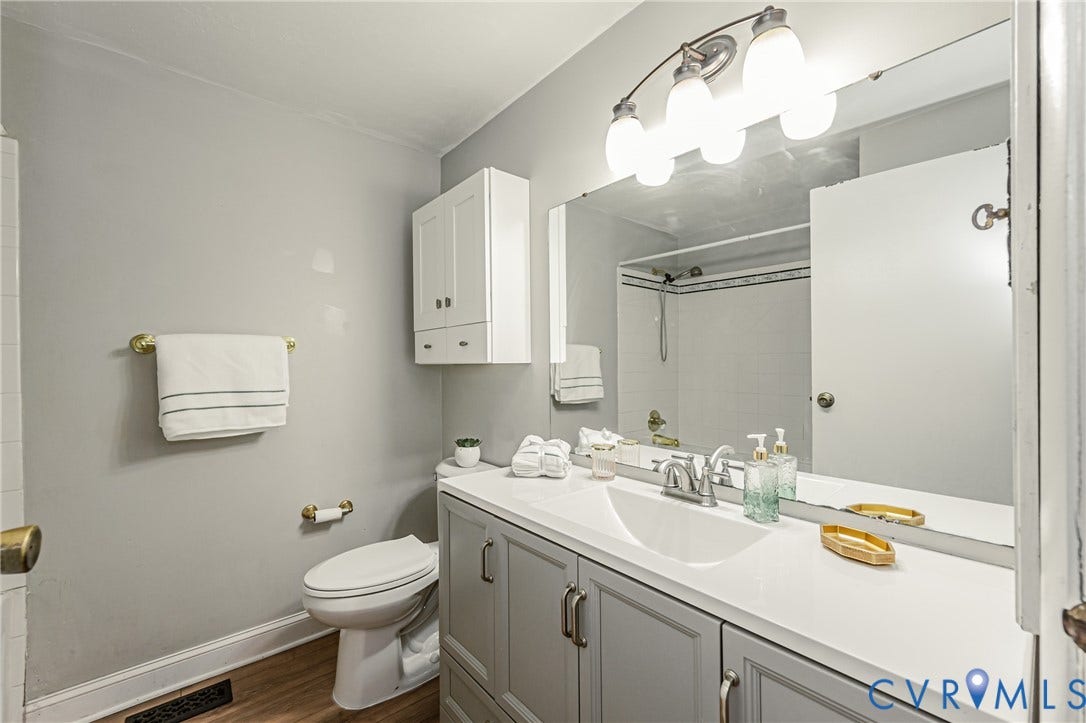 9406 Emmett Court, Glen Allen, VA 23060 Spa-inspired bathroom featuring a generous vanity with dual-sink configuration, abundant storage cabinetry, and brushed nickel hardware