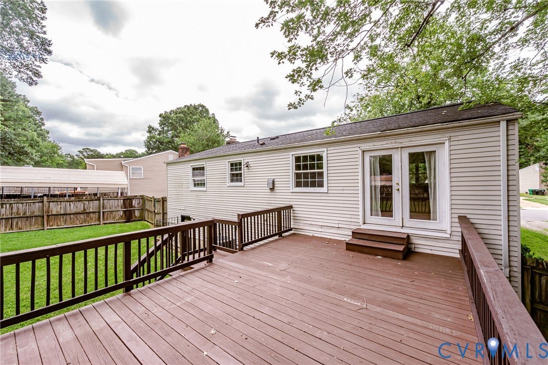 9406 Emmett Court, Glen Allen, VA 23060 Expansive composite deck featuring rich wood-finish decking, black aluminum railings, and multiple levels that extend across the rear of the property