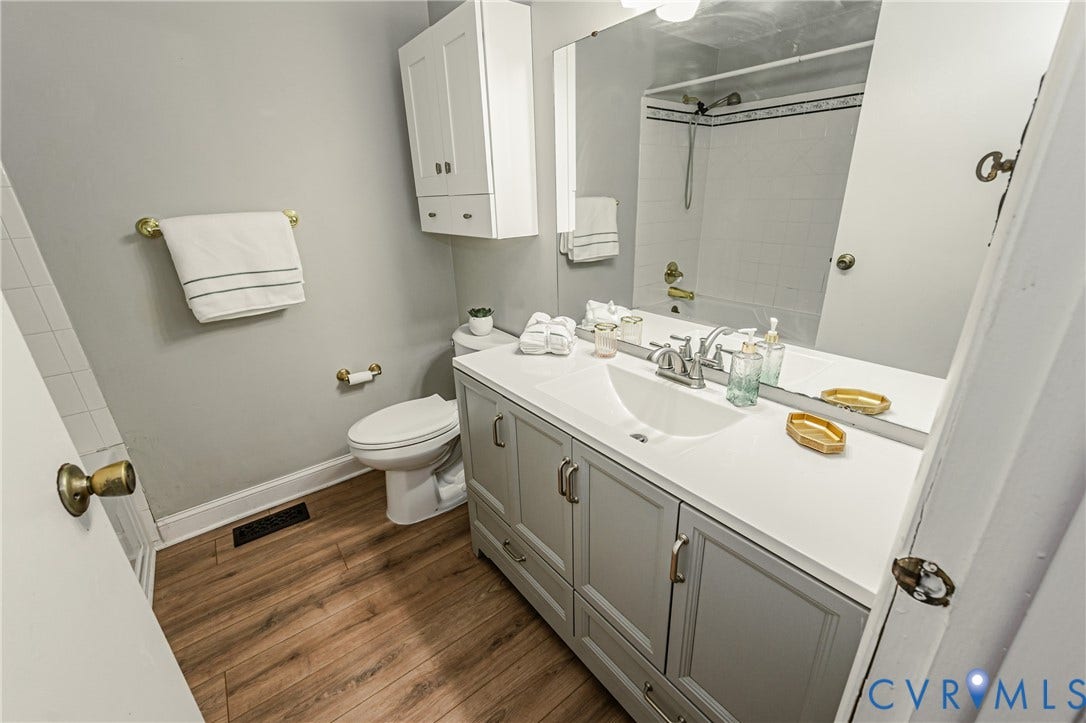 9406 Emmett Court, Glen Allen, VA 23060 Bathroom featuring a single vanity with light grey cabinetry, a white countertop, and a built-in sink