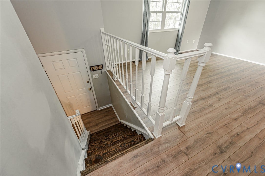 9406 Emmett Court, Glen Allen, VA 23060 Staircase featuring dark wood-finish treads and white balusters