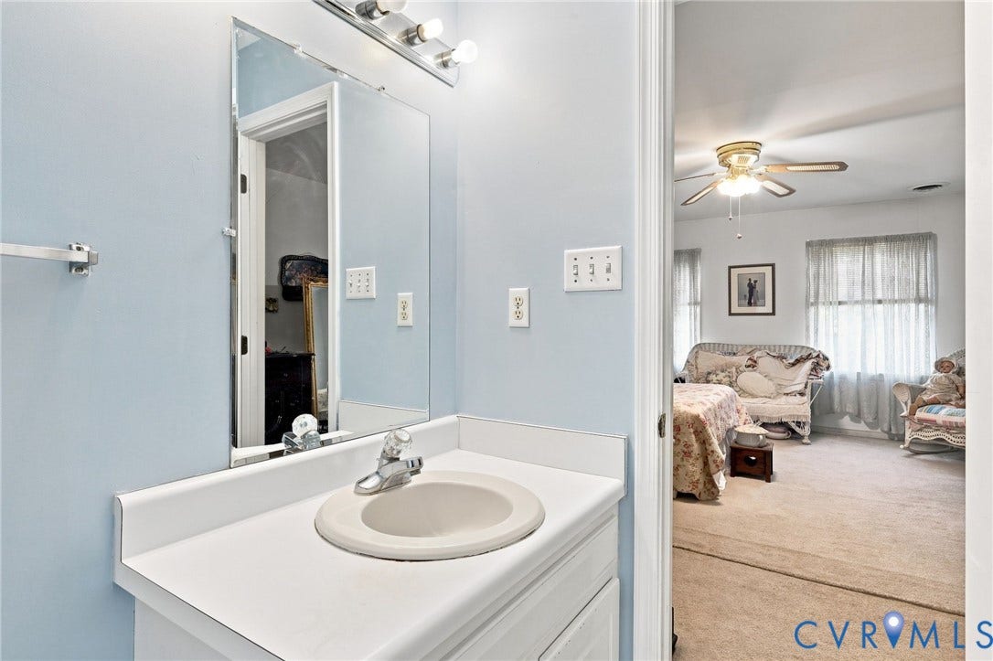 3819 Glen Oaks Court, Chester, VA 23831 Bathroom vanity featuring a single basin sink set in a white countertop, with a mirrored medicine cabinet above