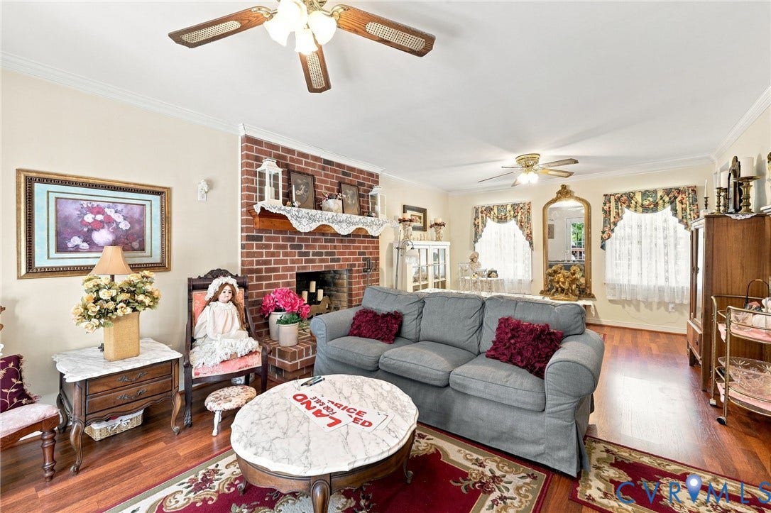 3819 Glen Oaks Court, Chester, VA 23831 Living area featuring a brick fireplace, wood-finish flooring, two ceiling fans, and crown molding