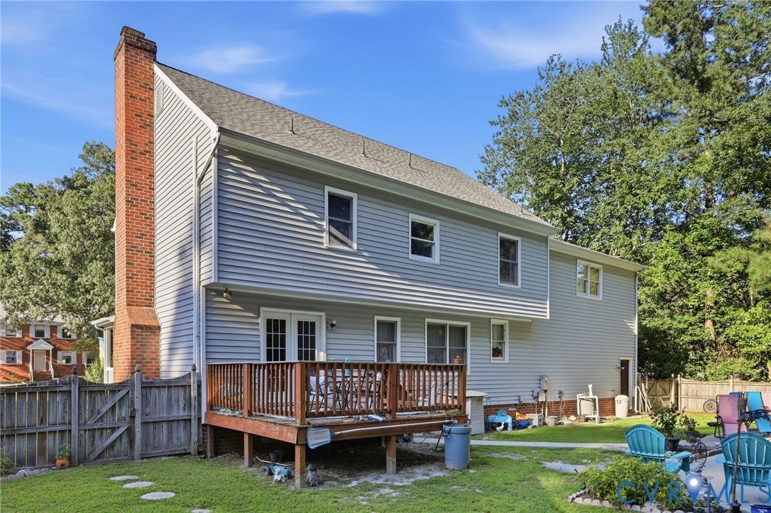 3819 Glen Oaks Court, Chester, VA 23831 Rear exterior featuring a wood deck, light gray siding, and a brick chimney