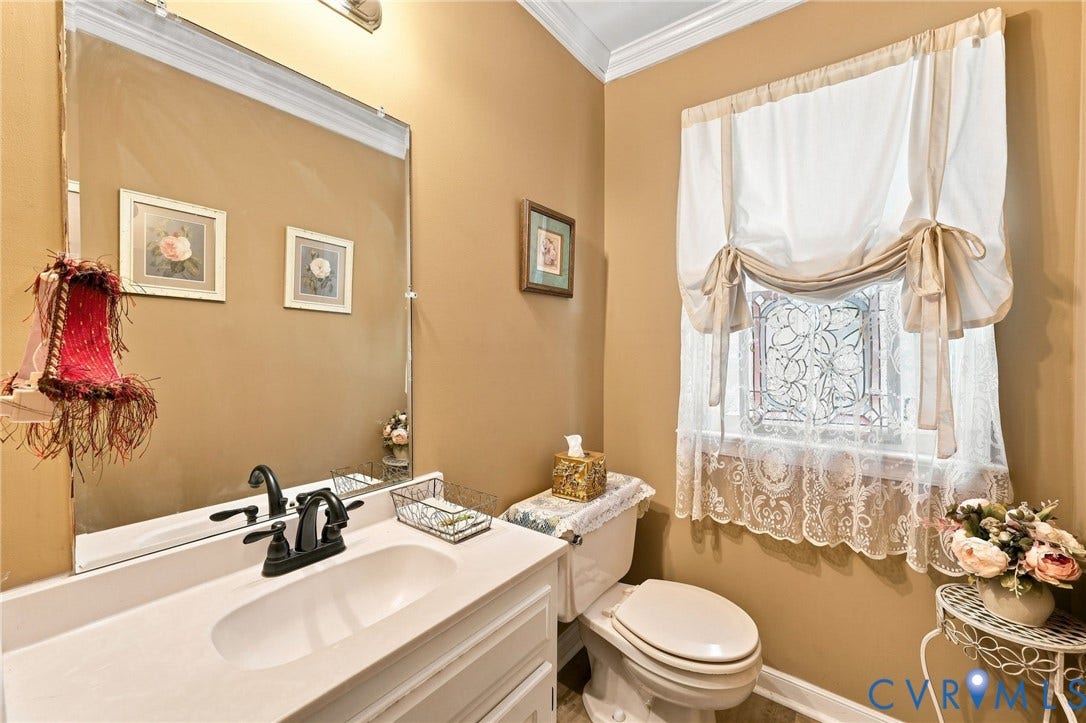 3819 Glen Oaks Court, Chester, VA 23831 Bathroom vanity featuring a white countertop with an integrated sink and matte black faucet and newer LVP flooring.